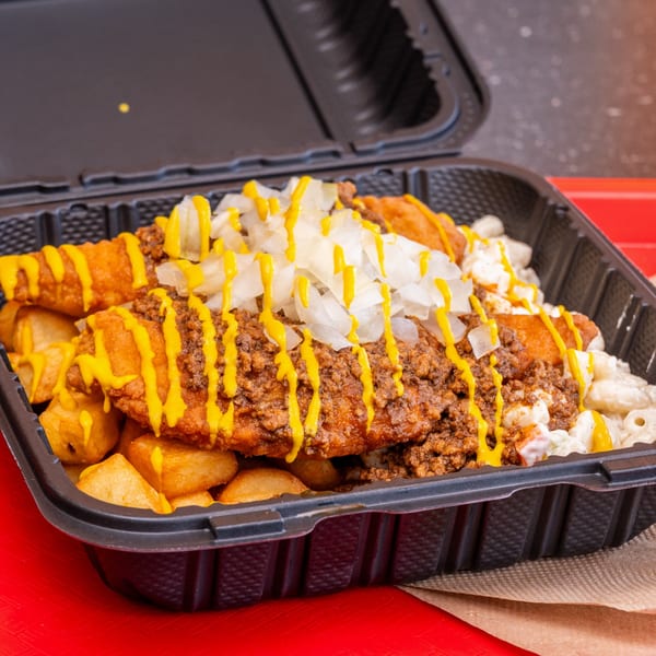 Chili Hots' chili mac with fried hot dogs, macaroni salad, home fries, mustard, and onions.